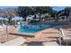 Community pool with lounge chairs and plenty of sun at 1610 Reynolds Rd # 211, Lakeland, FL 33801