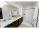 Modern bathroom with double vanity, granite countertops, and a shower at 1754 Eagle Hammock Blvd, Eagle Lake, FL 33839