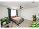 Bright bedroom with a ceiling fan, carpeted floors, and several potted plants at 1754 Eagle Hammock Blvd, Eagle Lake, FL 33839