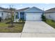 Charming blue two-story home with a white garage door and landscaped front yard at 1754 Eagle Hammock Blvd, Eagle Lake, FL 33839