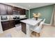 Kitchen island with seating, stainless steel appliances, and dark wood cabinetry at 1754 Eagle Hammock Blvd, Eagle Lake, FL 33839