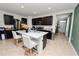 Modern kitchen with dark wood cabinets, stainless steel appliances, and an island with seating at 1754 Eagle Hammock Blvd, Eagle Lake, FL 33839