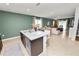 Kitchen island with granite countertop, sink, and dishwasher, overlooking the adjacent living room at 1754 Eagle Hammock Blvd, Eagle Lake, FL 33839