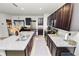 Modern kitchen with granite countertops, stainless steel appliances, and dark wood cabinets at 1754 Eagle Hammock Blvd, Eagle Lake, FL 33839