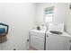 Compact laundry room with a washer, dryer, and storage space at 1754 Eagle Hammock Blvd, Eagle Lake, FL 33839