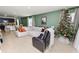Open concept living and dining area with white sectional, dining table, and Christmas tree at 1754 Eagle Hammock Blvd, Eagle Lake, FL 33839