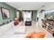 Living area with white sectional, recliner, decorated Christmas tree, and green accent wall at 1754 Eagle Hammock Blvd, Eagle Lake, FL 33839