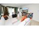 Living room featuring white sectional sofa, Christmas decor, and built-in shelves at 1754 Eagle Hammock Blvd, Eagle Lake, FL 33839