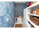 Well-organized pantry with blue patterned wallpaper, white shelves, and a coffee station at 1754 Eagle Hammock Blvd, Eagle Lake, FL 33839