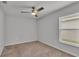 Cozy bedroom with carpet, ceiling fan, and a large window at 1968 Harvest Landing Cir, Lakeland, FL 33810