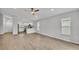 Open-concept living room and kitchen area with wood-look flooring at 1968 Harvest Landing Cir, Lakeland, FL 33810