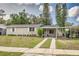 Single-story home with carport, landscaping, and dual driveway at 217 W Lake Ave, Auburndale, FL 33823