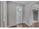 Hallway leading to a bathroom and kitchen with wood-look floors at 217 W Lake Ave, Auburndale, FL 33823