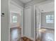 Hallway leading to bedrooms with wood floors and a closet at 217 W Lake Ave, Auburndale, FL 33823