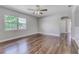 Spacious living room with polished wood floors and large windows at 217 W Lake Ave, Auburndale, FL 33823