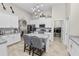 Kitchen featuring white cabinets, stainless steel appliances, an island with seating, and a laundry room at 303 Lake Mariana Pl, Auburndale, FL 33823