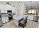 Bright open kitchen with white shaker cabinets, granite counters, and island with seating at 303 Lake Mariana Pl, Auburndale, FL 33823