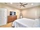 Bedroom with large bed, dresser, TV, and carpeted flooring at 3226 Oak Tree Ln, Winter Haven, FL 33884