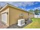 Side exterior view of a home with a generator, air conditioner unit, attached garage, and fenced yard at 3226 Oak Tree Ln, Winter Haven, FL 33884