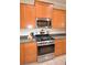 Close-up view of the kitchen's stainless steel oven, microwave, and dark countertops at 3226 Oak Tree Ln, Winter Haven, FL 33884