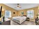 Cozy bedroom with a ceiling fan, ample natural light, and tile flooring at 4617 S Devon Ave, Lakeland, FL 33813