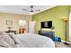 Large bedroom featuring tile floors, a ceiling fan, and an ensuite bathroom at 4617 S Devon Ave, Lakeland, FL 33813