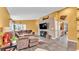 Inviting living room with a wood accent wall, fireplace, and view of the kitchen at 4617 S Devon Ave, Lakeland, FL 33813