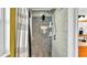 Walk-in shower with a pebble tile surround and built-in shelving at 4617 S Devon Ave, Lakeland, FL 33813