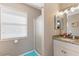 Clean bathroom with shower, granite vanity, and window with blinds at 535 Narrow Pond Rd, Polk City, FL 33868