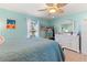 Bedroom with a queen bed, dresser, and beach-themed wall art at 535 Narrow Pond Rd, Polk City, FL 33868