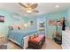 Main bedroom with a comfortable bed, dresser, and beachy decor at 535 Narrow Pond Rd, Polk City, FL 33868