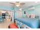 Bedroom with a queen bed, access to the kitchen and light decor at 535 Narrow Pond Rd, Polk City, FL 33868