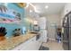Modern kitchen with white cabinets, granite counters, and teal backsplash at 535 Narrow Pond Rd, Polk City, FL 33868