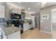 Modern kitchen with white cabinets, granite countertops, and stainless steel appliances at 535 Narrow Pond Rd, Polk City, FL 33868