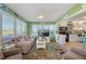 Bright living room features open floor plan with kitchen access, and comfortable seating at 535 Narrow Pond Rd, Polk City, FL 33868