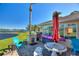 Outdoor patio with seating, grill, and lake view at 535 Narrow Pond Rd, Polk City, FL 33868