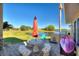Outdoor patio with seating, grill, and lake view at 535 Narrow Pond Rd, Polk City, FL 33868