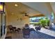 Covered patio with wicker furniture and fire pit at 535 Narrow Pond Rd, Polk City, FL 33868