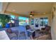 Covered patio with wicker furniture and fire pit at 535 Narrow Pond Rd, Polk City, FL 33868
