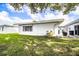 Backyard with green lawn, patio area, and attached storage at 540 Kelsey St, Lakeland, FL 33803