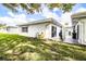 Backyard view with patio, lawn, and partial view of the house at 540 Kelsey St, Lakeland, FL 33803