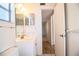 Bathroom with vanity sink, toilet, and a view into the hallway at 540 Kelsey St, Lakeland, FL 33803