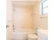 Bathroom with tiled walls, white tub, toilet, and vanity sink at 540 Kelsey St, Lakeland, FL 33803