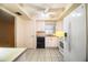 Bright kitchen with white appliances, ample counter space, and a ceiling fan at 540 Kelsey St, Lakeland, FL 33803