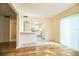 View of the kitchen from the adjacent dining/living area with wood-look floors at 540 Kelsey St, Lakeland, FL 33803