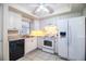 Bright kitchen featuring white cabinetry, modern appliances, and tile flooring at 540 Kelsey St, Lakeland, FL 33803