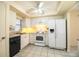 Clean kitchen featuring white appliances, plenty of cabinets, and tiled floors at 540 Kelsey St, Lakeland, FL 33803