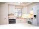 Practical kitchen with white cabinets, modern appliances, and a breakfast bar at 540 Kelsey St, Lakeland, FL 33803