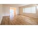 Spacious living room with wood-look flooring and large window providing natural light at 540 Kelsey St, Lakeland, FL 33803