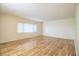 Open and airy living room with wood-style flooring and ample natural light at 540 Kelsey St, Lakeland, FL 33803